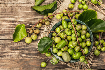 Harvest of ripe Actinidia arguta kiwi in a ceramic bowl