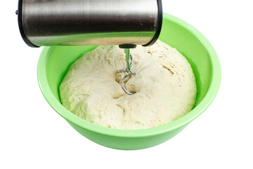 Large bowl with dough and electric mixer isolated on white, close-up, fresh homemade baking concept