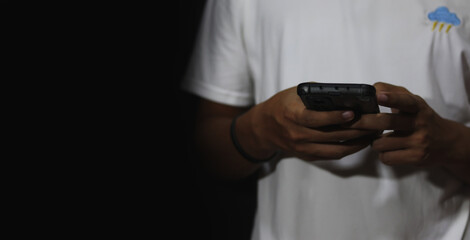 Close up of a man using mobile smart phone and copy space