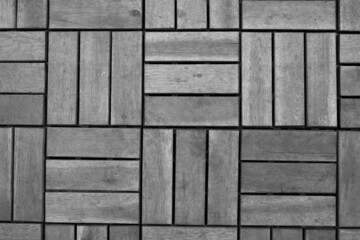 evocative black and white texture image of square shaped wooden dowels for flooring 