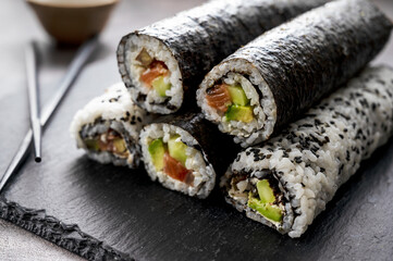 Sushi rolls. Homemade rolls with salmon, avocado and cucumber.