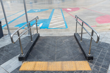 Concrete ramp way with stainless steel handrail for support wheelchair disabled people. Ramp way to support wheelchair disabled people.	