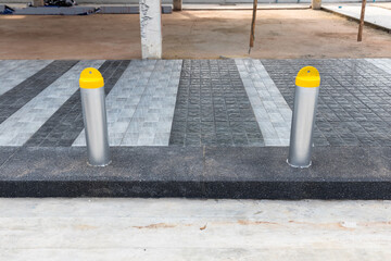 Traffic barrier pole on car parking lot. Steel bollards on footpath near city parking lot. Safety...