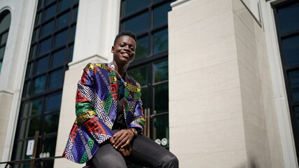 Portrait of young attractive stylish african american man model posing in casual clothes against neutral background looking sexy with afro hair. In People Youth Beauty and fashion concept.