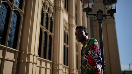 Portrait of young attractive stylish african american man model posing in casual clothes against neutral background looking sexy with afro hair. In People Youth Beauty and fashion concept.