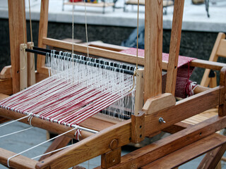 detail of a weaving loom exhibited in a fair 