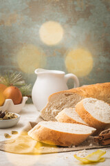Ingredients for preparing spanish torrijas, french toasts  or traditional Portuguese rabanadas for Christmas, made with slices of bread, eggs, cinnamon, milk and lemon peel