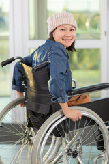 Fototapeta na wymiar asian woman in wheelchair in office