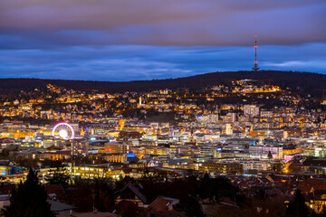 Stuttgart Cauldron nighttime panorama. Illuminated town at winter evening blue hour with hundreds of lights. Capital and largest city of the German state of Baden-Württemberg.  Cradle of automobile. - obrazy, fototapety, plakaty