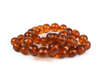 Beautiful necklace of amber beads on a white background