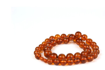 Beautiful necklace of amber beads on a white background
