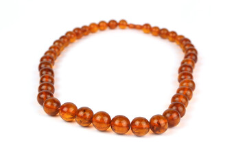 Beautiful necklace of amber beads on a white background