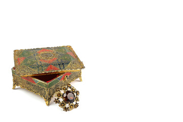 Old jewelry box and vintage brooch on a white background