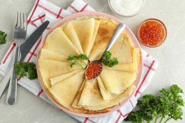 Concept of tasty food with crepes on light background