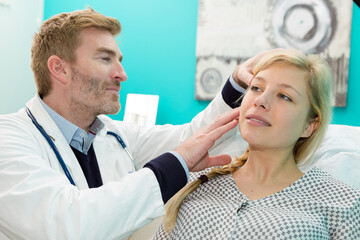 dermatologist examining patient in clinic closeup