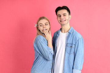 Cute and attractive couple on pink background