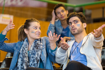 animated sport supporters wearing facepaint making hand gestures
