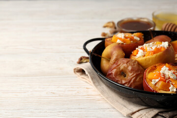 Concept of tasty food with baked apple on wooden background
