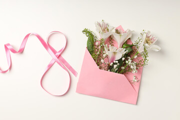 Envelope with flowers and 8 made of ribbon on white background