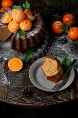 Homemade Citrus Tangerine cake decorated with powdered sugar and mandarin