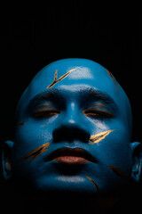 Bald man in blue makeup