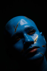 Bald man in blue makeup