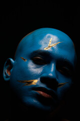 Bald man in blue makeup