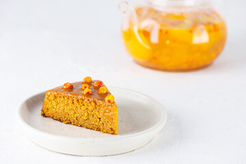 A piece of homemade vegan sea buckthorn pie, mannik with orange and tea. Sugar, gluten and lactose free.