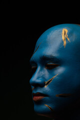 Bald man in blue makeup