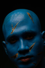 Bald man in blue makeup