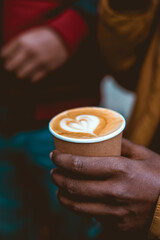 Person holding a cup of coffee