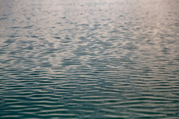 Blue water surface with waves and ripples
