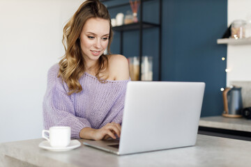 Fototapeta premium Young woman working at home, cozy portrait indoor