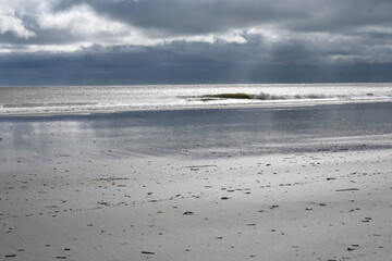Ocean beach in winter with dark clouds
