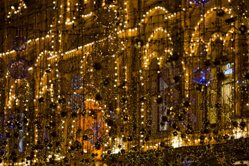 Christmas street decorations. Architecture, garlands, background image with bokeh