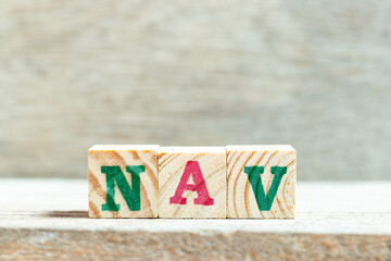 Alphabet letter block in word NAV (Abbreviation of Net asset value) on wood background