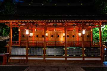 A Japanese shrine at the Fushimi Inari Taisha Shinto shrine in Kyoto Japan at night with its...
