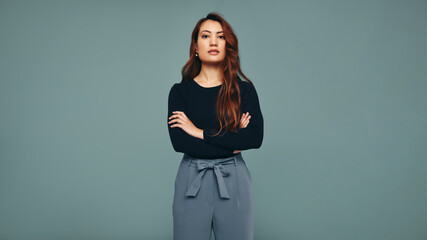 Independent young woman standing in a studio