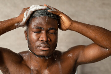 African American Guy Applying Shampoo On Hair Washing Head Indoor