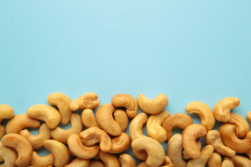 Cashew nuts on blue background. Top view.