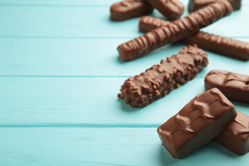 Mix of chocolate bars on blue wooden background. Top view.