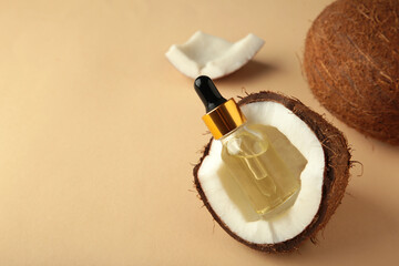 Coconut oil with coconut on beige background. Top view