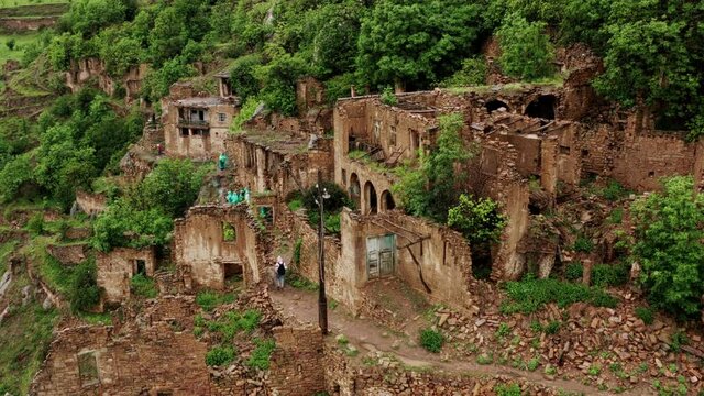 Abandoned in the mountains, the village of Gamsutl. Ghost town, ruins of an old settlement, Impregnable mountain fortress in the Dagestan mountains. Aerial view of an ancient village. 10 bit Video.