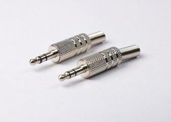 Metal mini Jack 3.5 connectors in silver color on a white background.