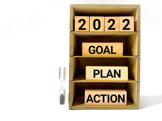 Inspirational and motivational concept - 2022 GOAL PLAN ACTION text on wooden blocks background. Stock photo.