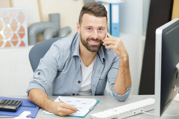 Fototapeta premium handsome man on the phone in the office