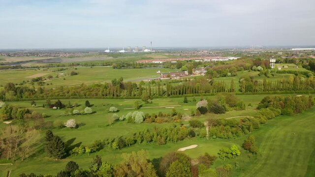 Aerial footage of the Pontefract race course located in the town of Pontefract in West Yorkshire in the UK, showing the main building and horse racing course, with the town of Castleford in the back