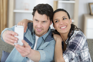 young couple pose for selfie taken on phone