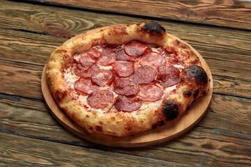 Pepperoni pizza on rustic, vintage style wood background. Top view
