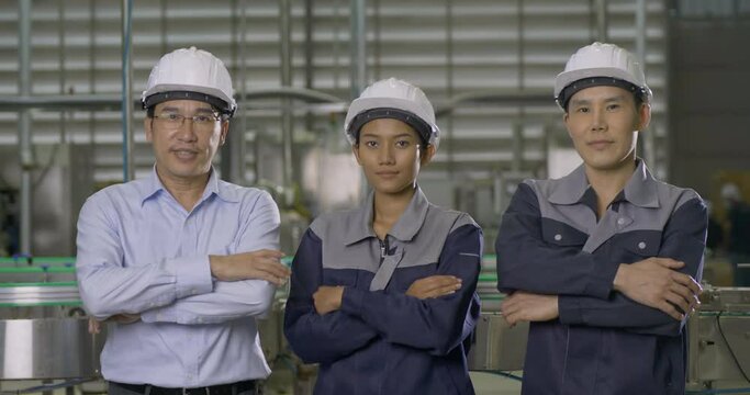 Group of engineer looking to camera at modern factory. They looking to camera with confident.